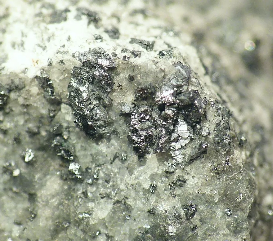 Tiemannite crystals on calcite, El Doctor mine, Querétaro, Mexico. Field of view 5 mm.
